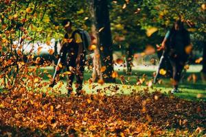 People operating a heavy duty leaf blower. photo