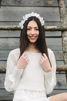 Lovely girl near a wooden house photo