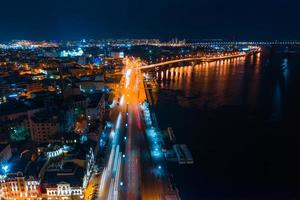 Highway at night in modern city. Aerial view of cityscape photo