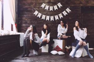 Four charming model posing on a vintage New Year's background photo