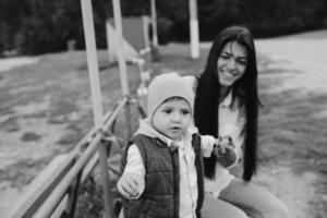 Mother and young son together on a bench photo