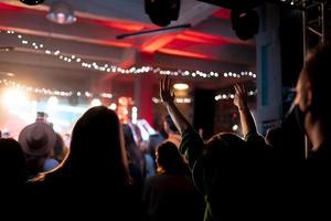 Photo of many people enjoying rock concert in nightclub