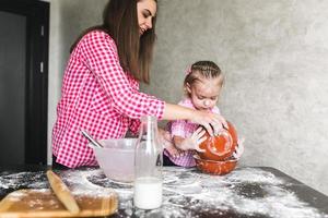 Mom and daughter together in the kitchen photo