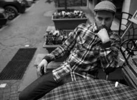 The man in the authentic boots and selvedge jeans  sitting at the table photo