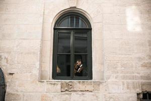 Wedding couple kissing in the window photo