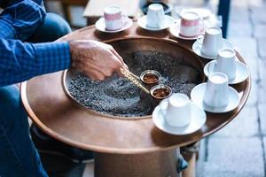 A man make Turkish coffee photo