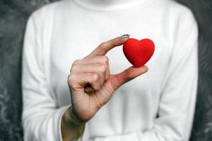 Girl holding a small lovely heart photo