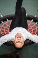 Young woman rides on a swing at the playground. photo