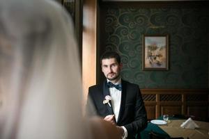 bride and groom are sitting opposite each other photo