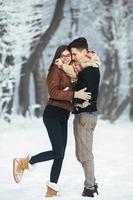 Happy couple in snow park photo