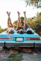 Three girls are lying on the trunk photo