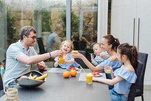 Happy family eating fresh fruit breakfast photo