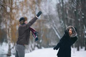 man and woman throwing snowballs photo