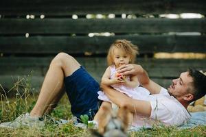 Happy family on lawn in the park photo