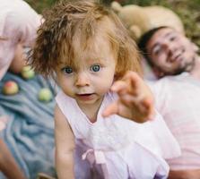 Father, mother and daughter in the park photo