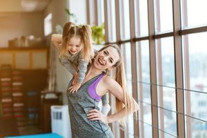 Mom and daughter together perform different exercises photo