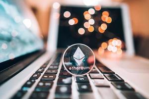 Ethereum coin money on computer laptop keyboard photo