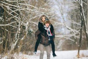 man carries a girl on his back photo