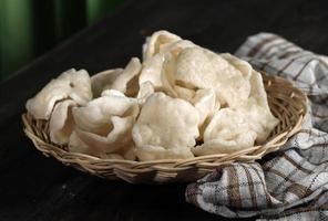 Krupuk Upil or Krupuk Mlarat, Indonesian Popular Cracker made from Cassava Flour and Fried without Oil. Mlarat Means Poor photo