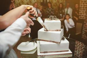 bride and groom is cutting cake photo