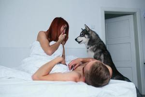 Young adult couple lying on bed photo