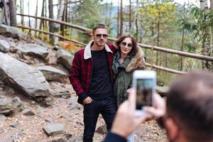 guy and girl are posing on camera photo