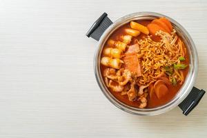 Budae Jjigae or Budaejjigae. It is loaded with Kimchi, spam, sausages, ramen noodles and much more photo