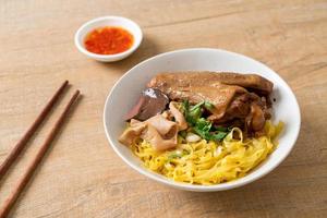 Egg noodles served dry with braised duck photo
