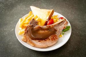 pork chop steak with chips and mini salad photo