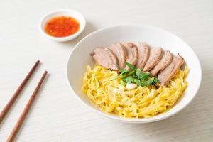 dried duck noodles in white bowl photo