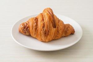 fresh croissant on white plate photo