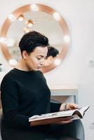 Attractive woman at the mirror in beauty studio photo