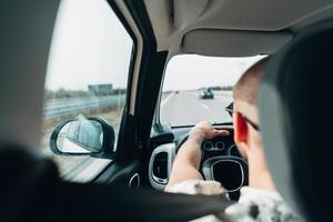 The man in the car traveling on the road photo