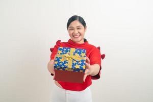 happy Asian woman wearing red shirt with gift box on hand for Christmas festival photo