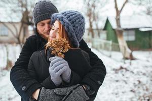 man hugging his girlfriend on the street photo