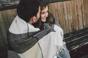 Young couple wrapped in plaid photo