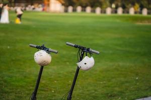 two electric kick scooters or e-scooter parked on the sidelines road photo