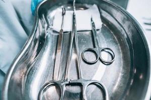 Several surgical instruments lie on a tray photo