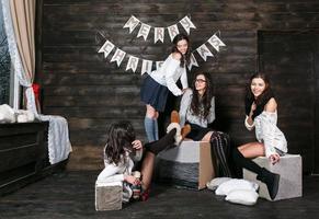 Four charming model posing on a vintage New Year's background photo