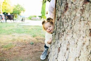 Cute little girl is playing outdoors photo
