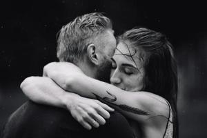 beautiful couple hugging in the rain photo