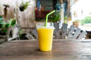 mango smoothies in take away glass photo