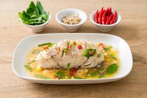 steamed sea bass fish with herbs photo