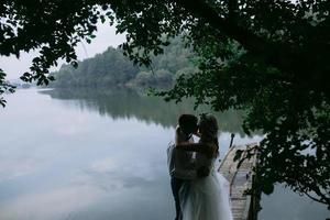 Wedding couple on the old wooden pier photo