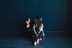 beautiful girls sit by the wall and pose photo