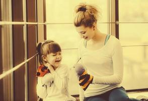 Mother and daughter have fun in the gym photo