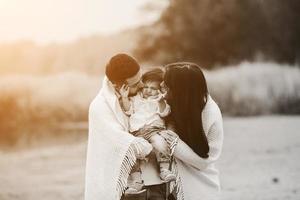 Young family together in nature with a little boy photo