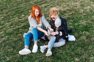 Mom and aunt play with a boy in the Park photo