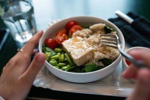 Healthy breakfast bowl with porridge and fresh vegetable salad photo