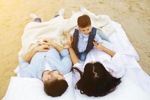 Happy family relaxing together on the mattress photo